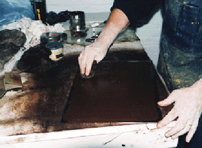 INKING THE PLATE - A special mixture of inks, representing a sepia tone, are mixed and applied to the entire face of the plate.